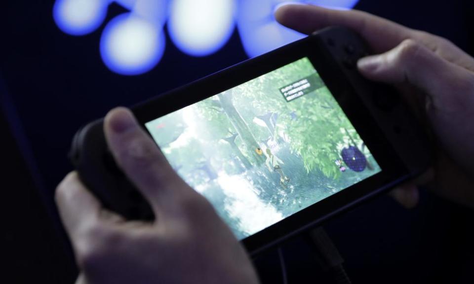 An attendee plays “The Legend of Zelda: Breath of the Wild” video game on a Nintendo Co. Switch game console during an unveiling event in Tokyo, Japan