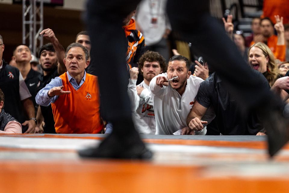 OSU wrestling coach John Smith, left, and associate head coach Coleman Scott, right, react on the sidelines at a match against Iowa on Feb. 25 in Gallagher-Iba Arena in Stillwater.