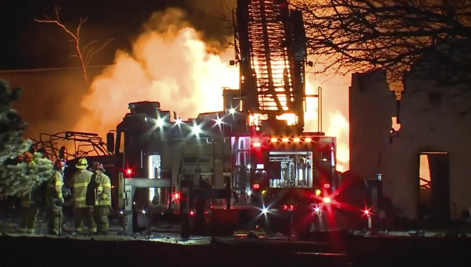 In this frame grab taken from video provided by WXYZ, firefighters battle an industrial fire in the Detroit suburb of Clinton Township, late Monday, March 4, 2024. (Courtesy of WXYZ via AP)