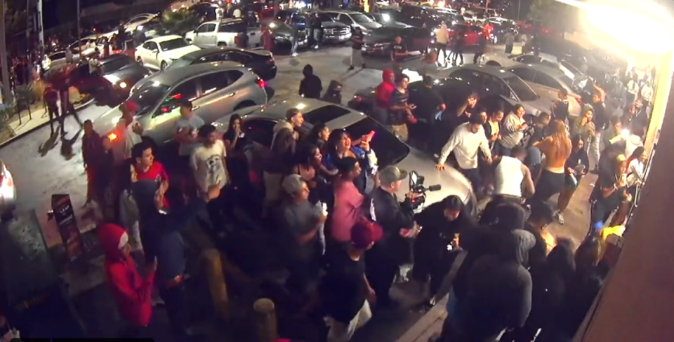 A flash mob of more than a dozen people began forming outside a 7-11 after several cars parked in the middle of a busy intersection to do donuts (LAPD)