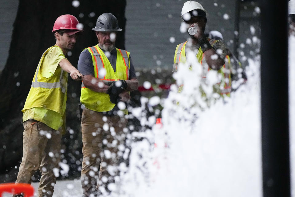 Crew members watch a broken water transmission line, Saturday, June 1, 2024, in Atlanta. Much of Atlanta, including all of downtown, has been without water since Friday afternoon after crews began work to repair breaks on transmission lines in the downtown area. (AP Photo/Mike Stewart)