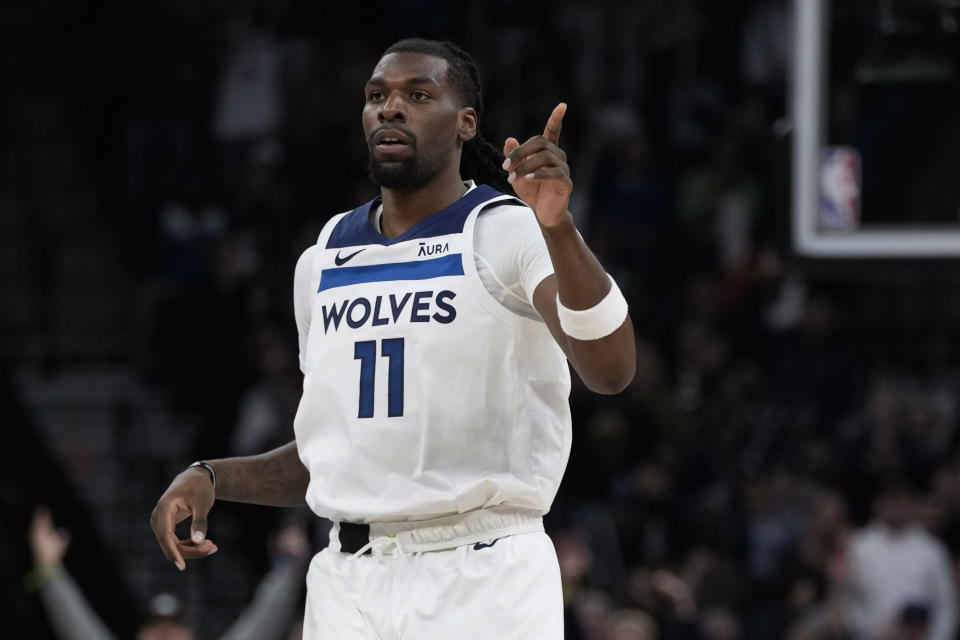 Minnesota Timberwolves center Naz Reid (11) points after making a three-point basket during the first half of an NBA basketball game against the Boston Celtics, Monday, Nov. 6, 2023, in Minneapolis. (AP Photo/Abbie Parr)