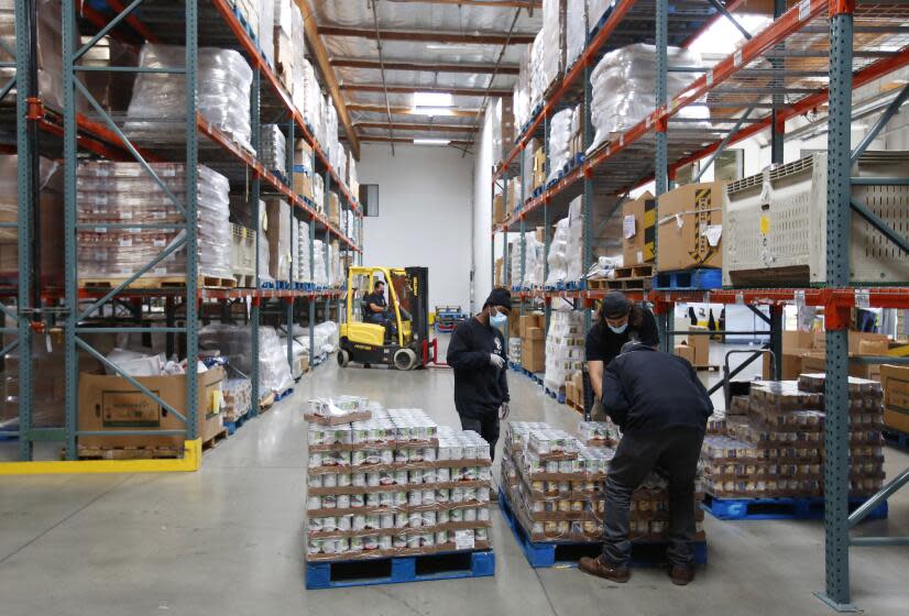 Workers sort food at the Jacobs & Cushman San Diego Food Bank on April 14, 2020.