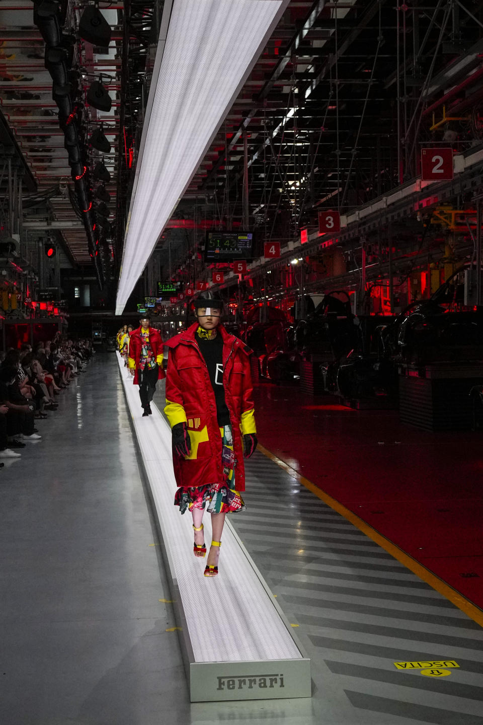 A model wears a creation as part of the Ferrari women's and men's Spring Summer 2022 collection, in Maranello, Italy, Sunday, June 13, 2021. (AP Photo/Antonio Calanni)