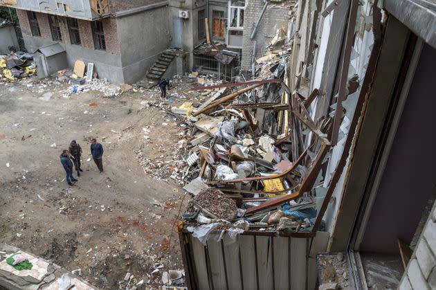 Residents stand in the backyard of their building, which was damaged in a Russian missile attack in the center of Kharkiv, Ukraine, on Tuesday. (Photo: Anadolu Agency via Getty Images)