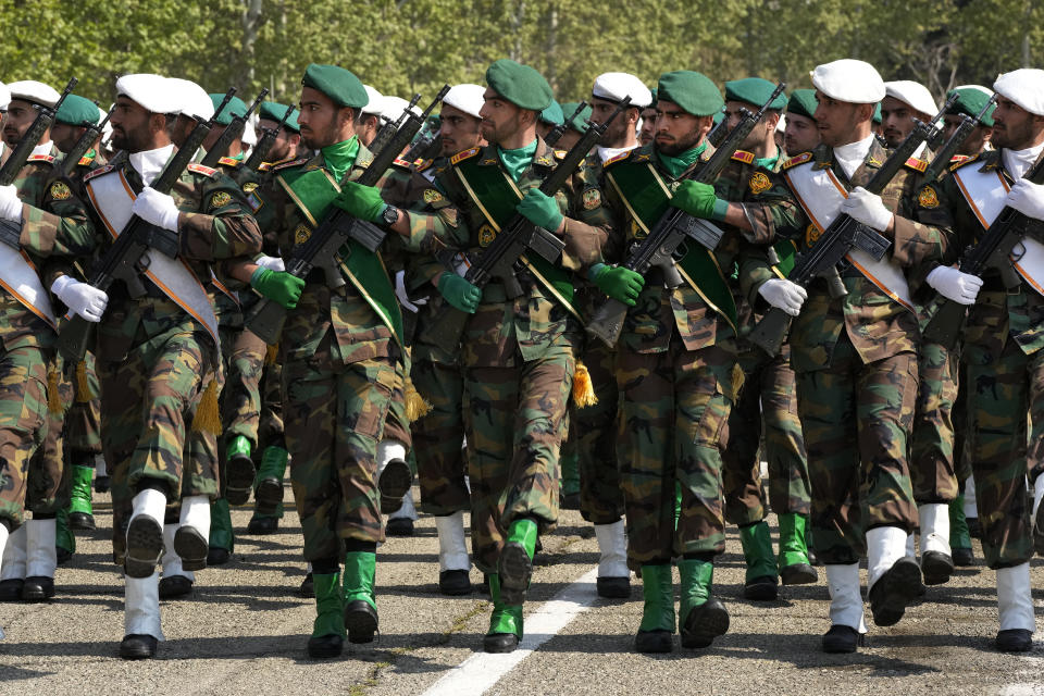 Iranian army members march during Army Day parade at a military base in northern Tehran, Iran, Wednesday, April 17, 2024. In the parade, Iranian President Ebrahim Raisi warned that the "tiniest invasion" by Israel would bring a "massive and harsh" response, as the region braces for potential Israeli retaliation after Iran's attack over the weekend. (AP Photo/Vahid Salemi)