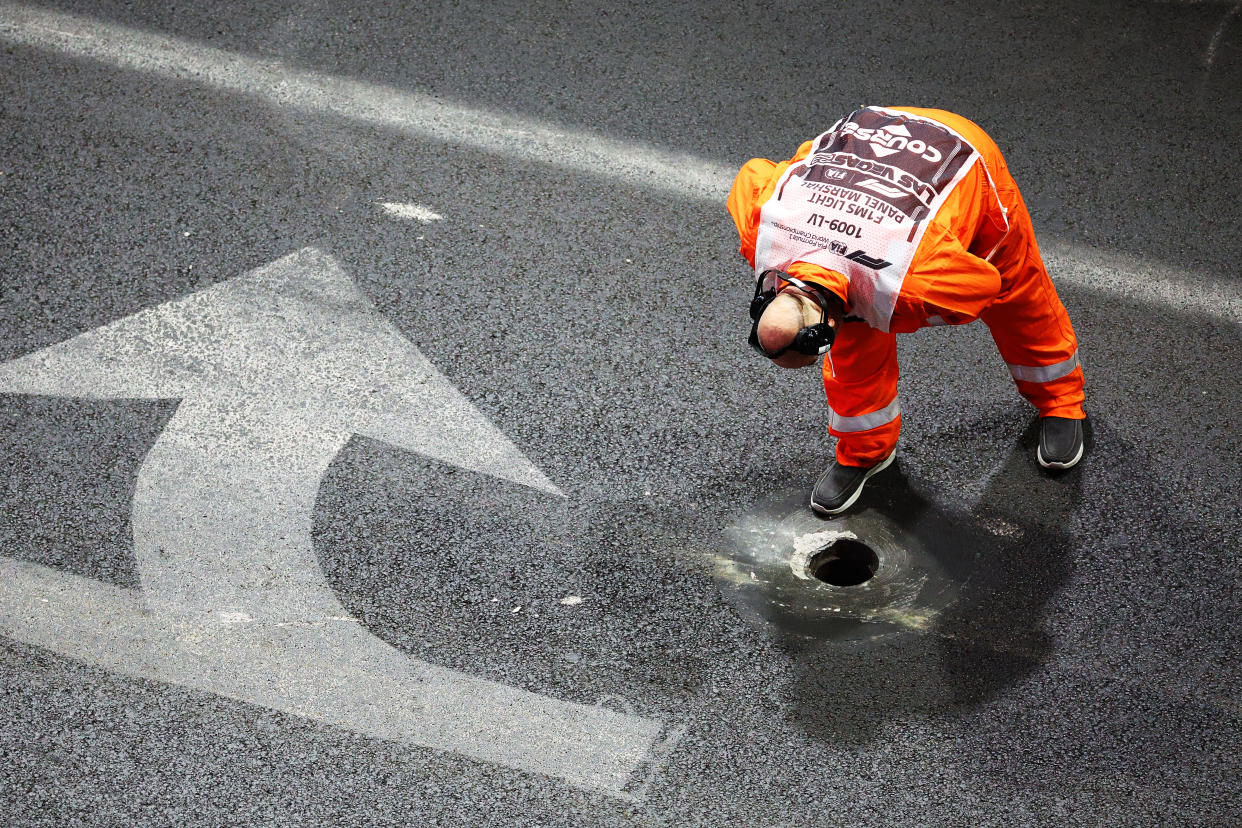 LAS VEGAS, NEVADA - NOVEMBER 16: A track marshal inspects an area of track near a drain as seen from the McLaren VISTA during practice ahead of the F1 Grand Prix of Las Vegas at Las Vegas Strip Circuit on November 16, 2023 in Las Vegas, Nevada. (Photo by Jared C. Tilton - Formula 1/Formula 1 via Getty Images)