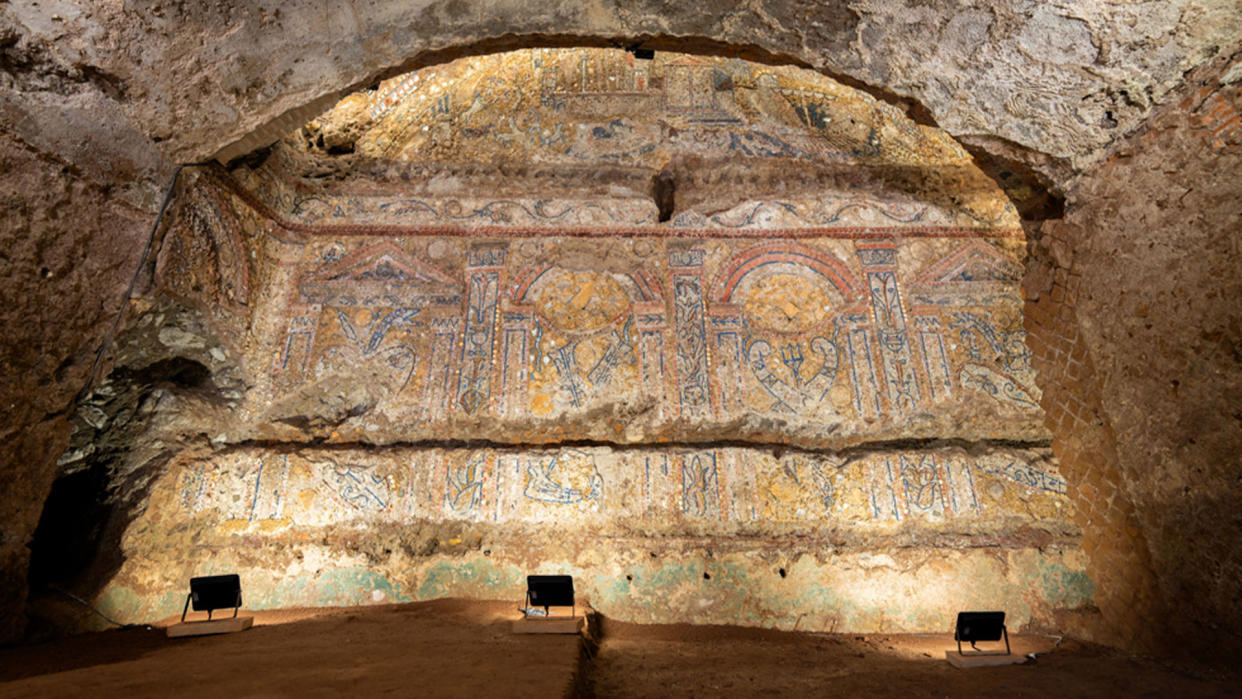  A mosaic covers the wall of a banquet hall, shaped to imitate a cave, in Roman remains. 