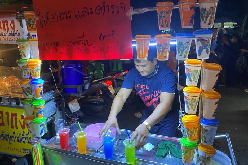 Thai drink seller, Komsan Moonsan is seen with his cart during an anti-government protest in Bangkok