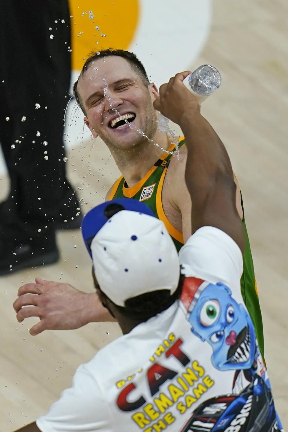 Utah Jazz guard Donovan Mitchell pours water over forward Bojan Bogdanovic as they celebrate the team's victory over the Denver Nuggets in an NBA basketball game Friday, May 7, 2021, in Salt Lake City. (AP Photo/Rick Bowmer)