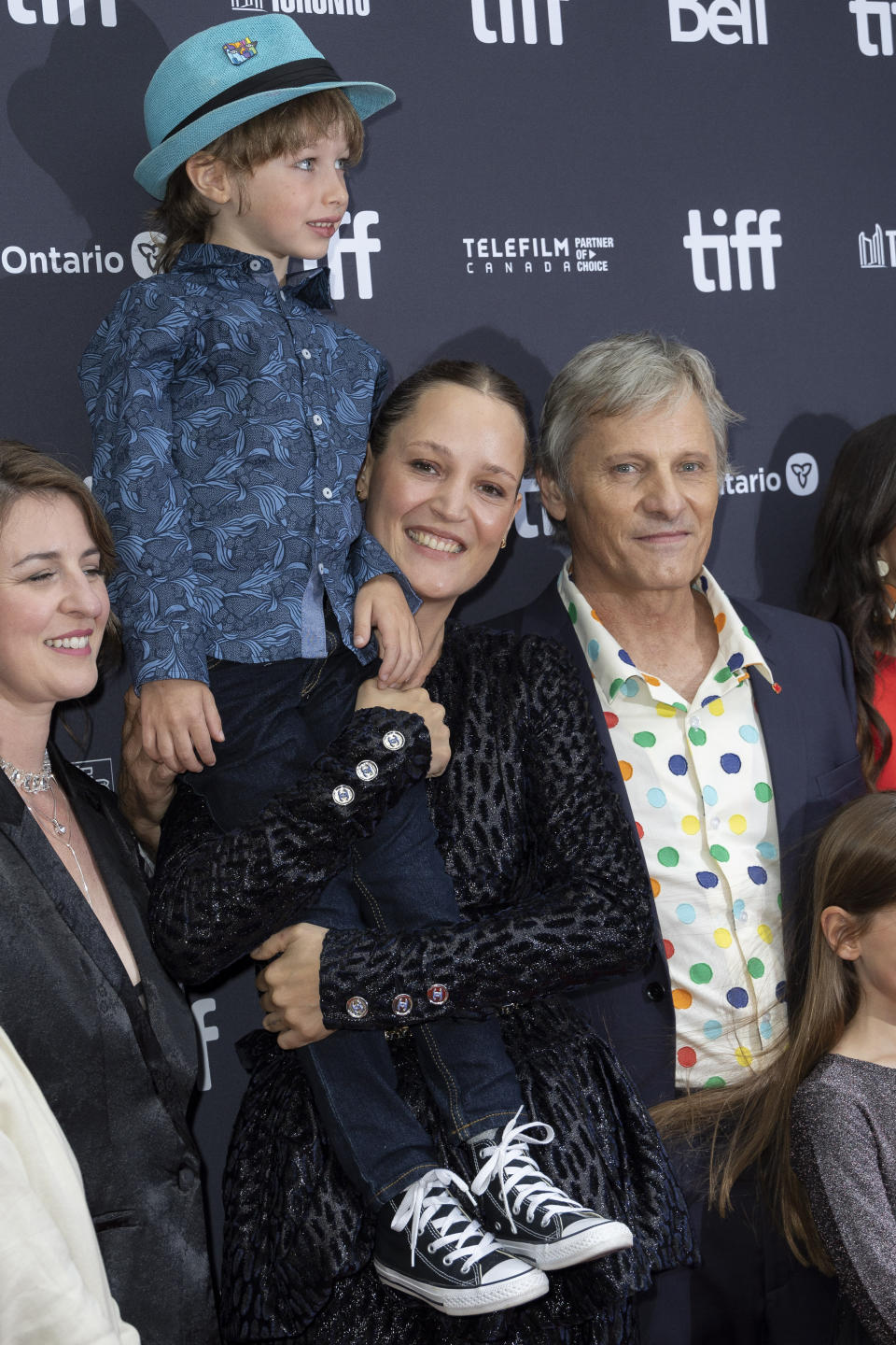 Vicky Krieps holds Atlas Green in her arms as Viggo Mortensen, right and Veronique Chaumont look on, as they attend the premiere of "The Dead Don't Hurt" at the Princess of Wales Theatre during the Toronto International Film Festival, Friday, Sept. 8, 2023, in Toronto. (Photo by Joel C Ryan/Invision/AP)