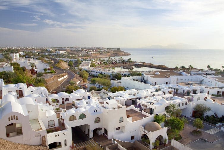 White houses and the sea in the distance.