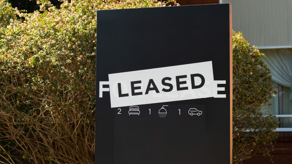 A 'leased' sign in front of a home in Australia amid rental crisis.