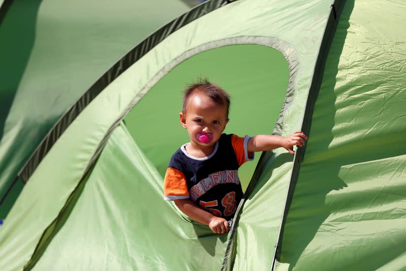 A child from the destroyed Moria camp for refugees and migrants is seen in a tent at the Community Center managed by Team Humanity