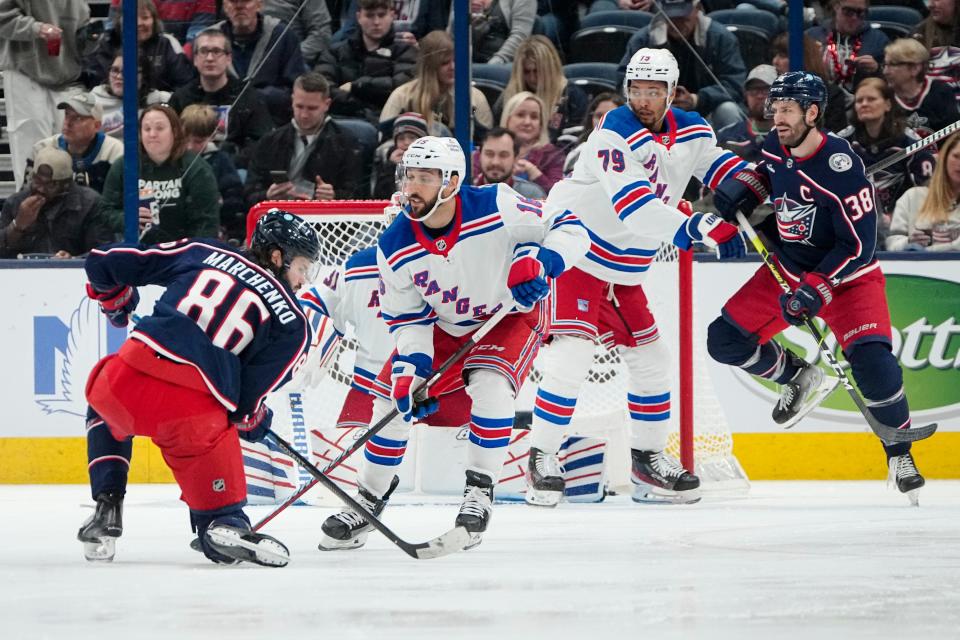 Columbus Blue Jackets right wing Kirill Marchenko (86) tries to shoot past New York Rangers center Vincent Trocheck (16) during the second period of the NHL hockey game at Nationwide Arena on April 8, 2023. 