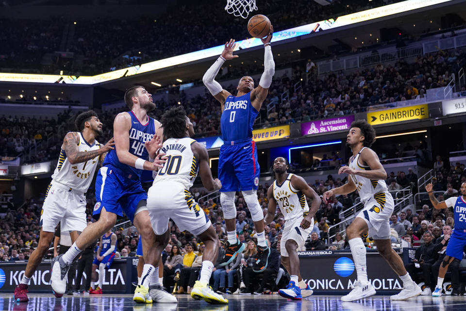 Los Angeles Clippers guard Russell Westbrook (0) shoots over Indiana Pacers guard Bennedict Mathurin (00) during the second half of an NBA basketball game in Indianapolis, Monday, Dec. 18, 2023. (AP Photo/Michael Conroy)