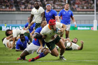 South Africa's Schalk Brits scores a try as he is tackled by Namibia's Eugene Jantjies during the Rugby World Cup Pool B game at the City of Toyota Stadium between South Africa and Namibia in Toyota City, Japan, Saturday, Sept. 28, 2019. (AP Photo/Christophe Ena)