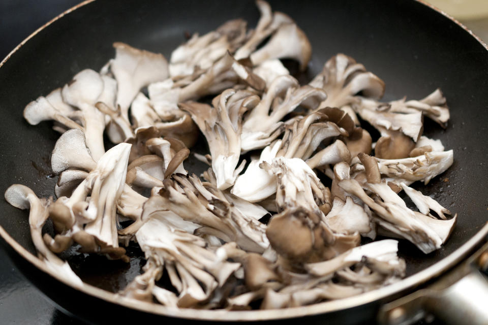 Stir-fry the maitake mushrooms in a frying pan (karimitsu / Getty Images/iStockphoto)