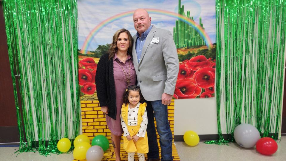 Michael and Cassidy James pose with their newly adopted daughter Kazlynn during the "Wizard of Oz" themed National Adoption Day event held Nov.17 at the Randall County Courthouse in Canyon.