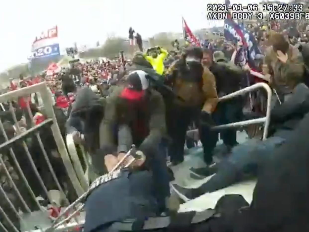 Body camera footage appears to show a police officer being dragged into the pro-Trump mob laying siege to the US Capitol on 6 January, 2021.  (US Department of Justice)