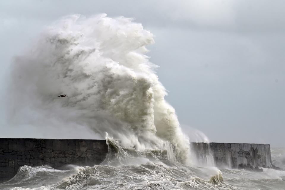 Large waves crash over the harbour wall and Newhaven Lighthouse on the south coast of England on August 25, 2020. - Wind gusts of 70mph are expected as Storm Francis brings rain and high winds to the country. (Photo by GLYN KIRK / AFP) (Photo by GLYN KIRK/AFP via Getty Images)