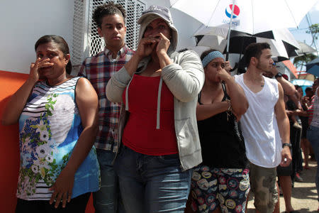 People wait in line for aid items to be handed out in San Juan. REUTERS/Alvin Baez