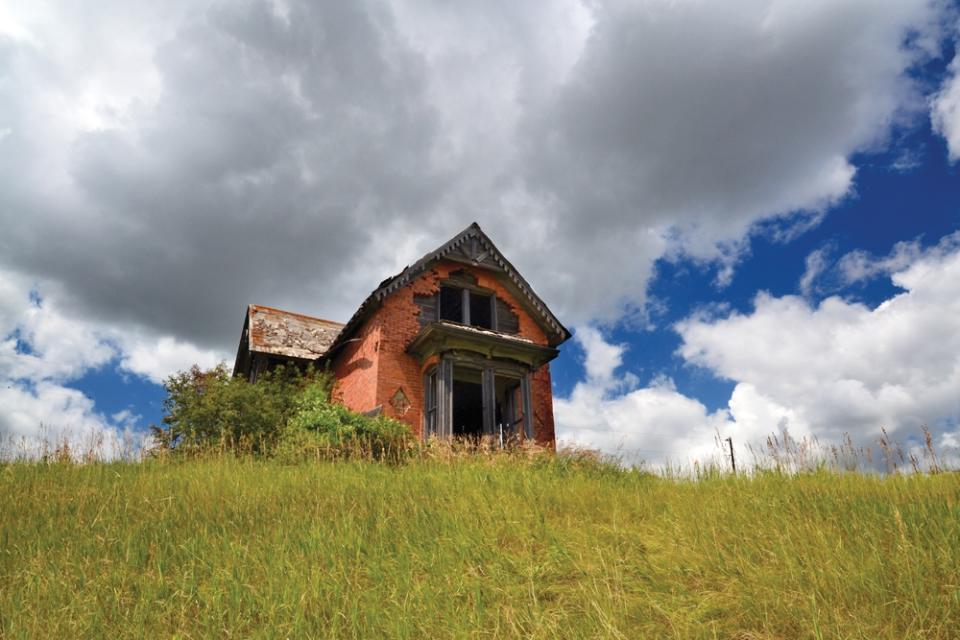 This photo provided by Troy Larson shows an abandoned house in Sims, N.D., and is featured on the cover of the book "Ghosts of North Dakota Volume 2," which documents ghost towns throughout the state. (AP Photo/Troy Larson)
