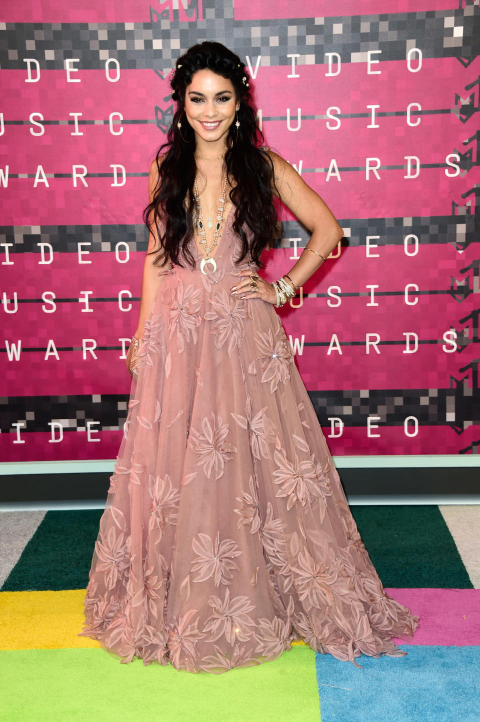 Dropping jaws in a fairytale-esque rose pink floral gown, Vanessa Hudgens also managed to wear an impressive 28 pieces of jewellery for her red carpet look. [Photo: Getty]