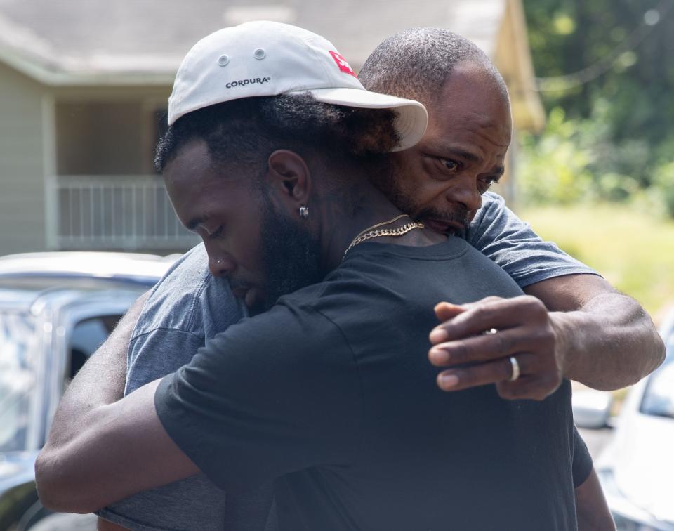 A neighbor, who did not want to be named, walks over to hug Marcus Cash as he stands outside the house Thursday, Sept. 8, 2022, where his friend Dewayne Tunstall was killed in Memphis. Police say Ezekiel Kelly, 19, is responsible for the shooting along with seven others on Wednesday. Cash said he and Tunstall had been friends for 6 years and were planning on opening a food truck together. “Now, my other half gone to my business, my other part of my brain,” said Cash. He later added, “I’m tore up. I done cried all I can cry.”