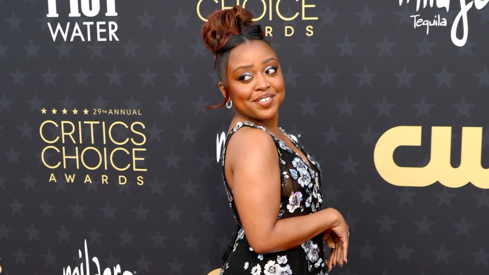 “Abbott Elementary” actor Quinta Brunson wore a sheer black Georges Hobeika dress with silvery embroidered flower accents and Nicole Rose jewelry. - Frazer Harrison/Getty Images