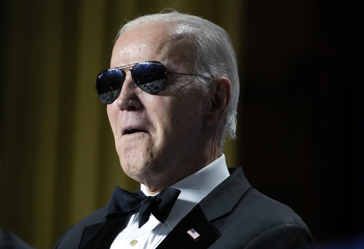 President Joe Biden wears sunglasses after making a joke about becoming the 