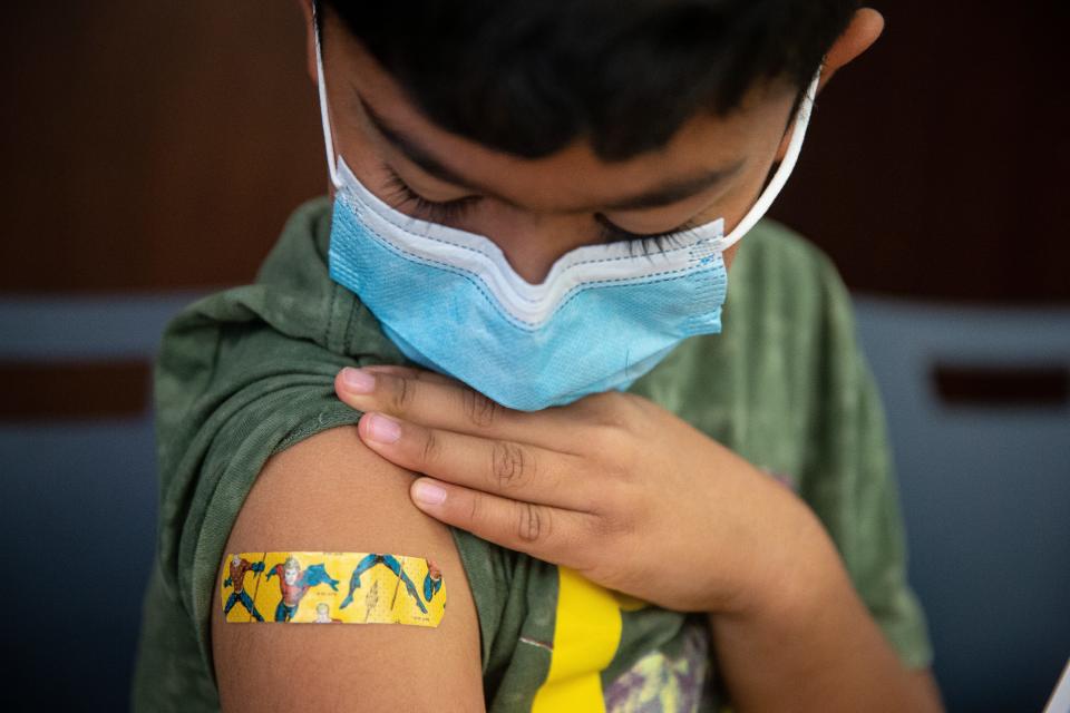 Adam Acevedo, 7, shows off his Aquaman bandage after receiving a COVID-19 vaccine on Saturday, Nov. 13, 2021, at La Palmera mall in Corpus Christi, Texas.  