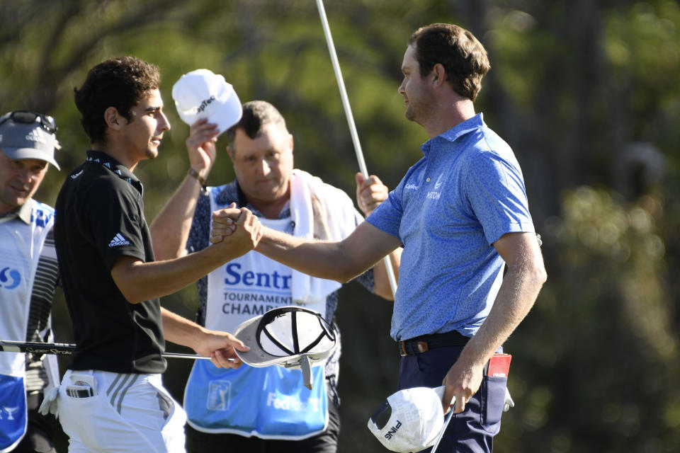 Champion Harris English, right, greets runner up Joaquin Niemann after the final round of the Tournament of Champions golf event, Sunday, Jan. 10, 2021, at Kapalua Plantation Course in Kapalua, Hawaii. (Matthew Thayer/The Maui News via AP)
