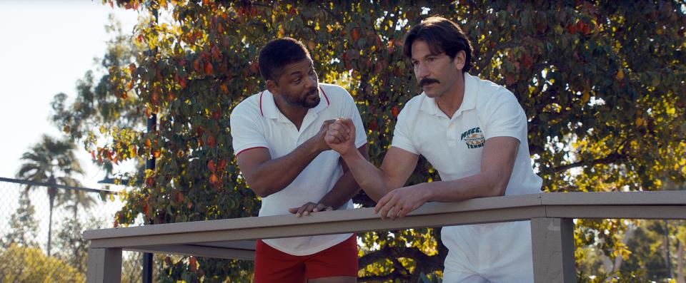 Richard Williams (Will Smith, left) enlists tennis coach Rick Macci (Jon Bernthal) to train his daughters in "King Richard."