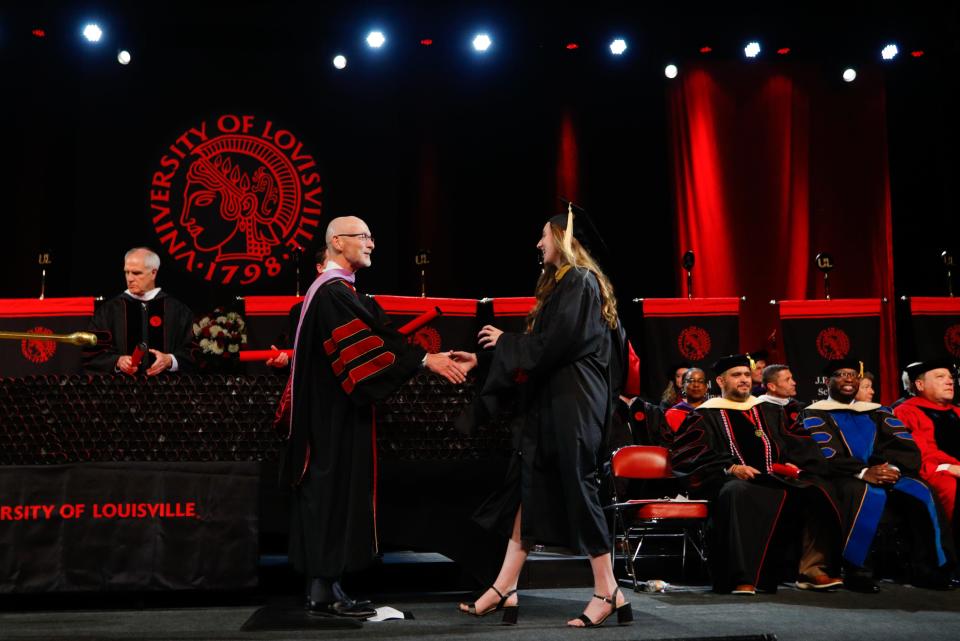 University Provost Gerry Bradley hands out a diploma at the 10 a.m. spring 2024 commencement ceremony for the University of Louisville. 
May 11, 2024