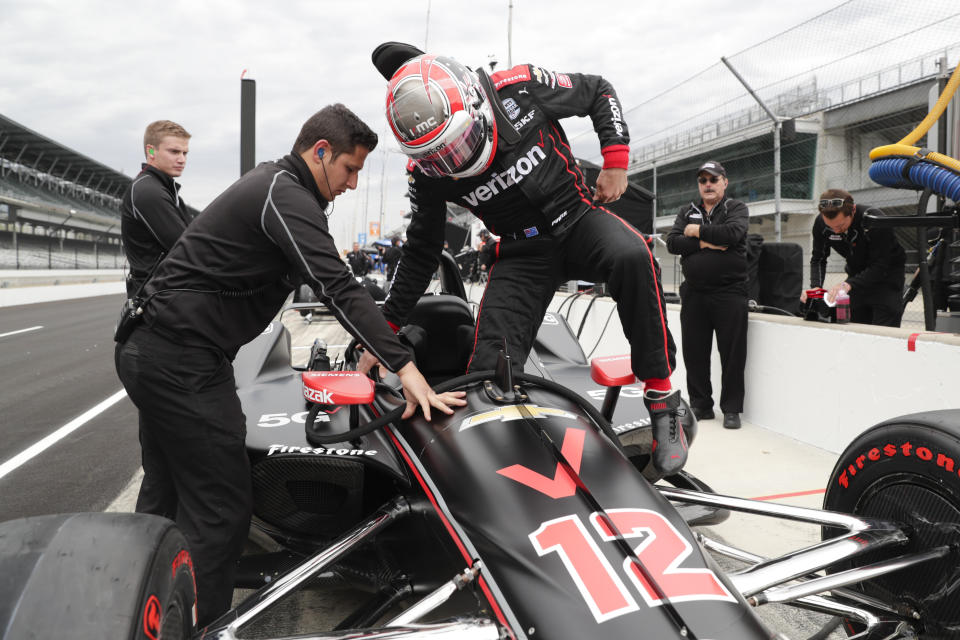 IndyCar driver Will Power, of Australia, climbs into his car during auto racing testing at the Indianapolis Motor Speedway in Indianapolis, Wednesday, April 24, 2019. (AP Photo/Michael Conroy)