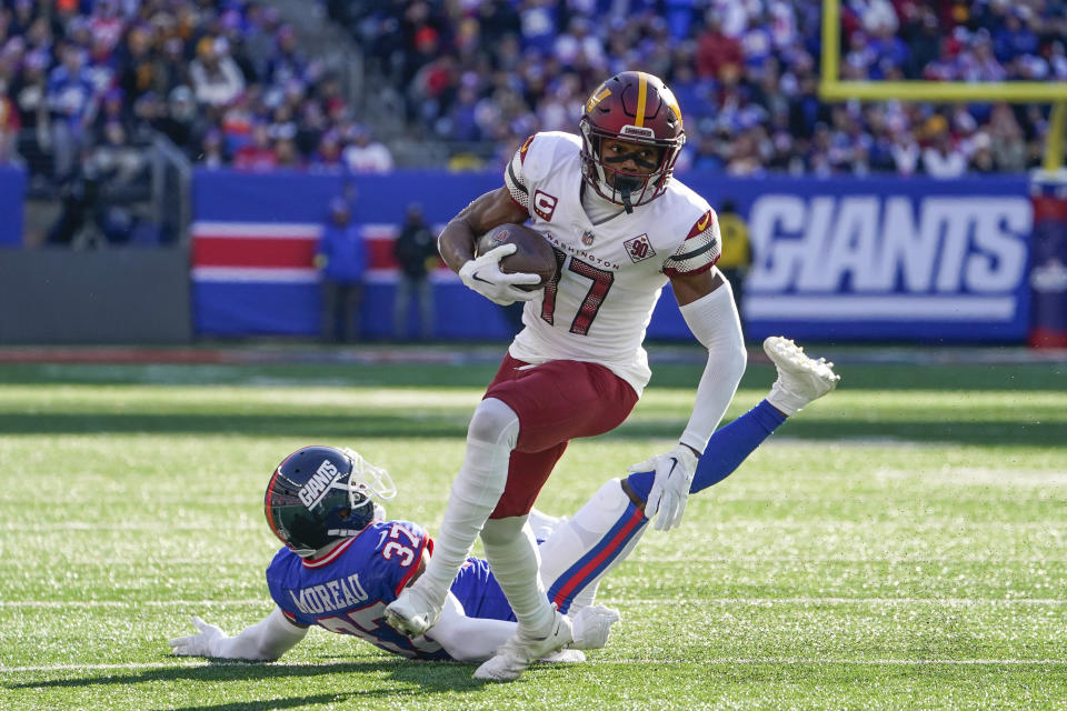 Washington Commanders' Terry McLaurin breaks a tackle to score a touchdown during the first half of an NFL football game against the New York Giants, Sunday, Dec. 4, 2022, in East Rutherford, N.J. (AP Photo/John Minchillo)