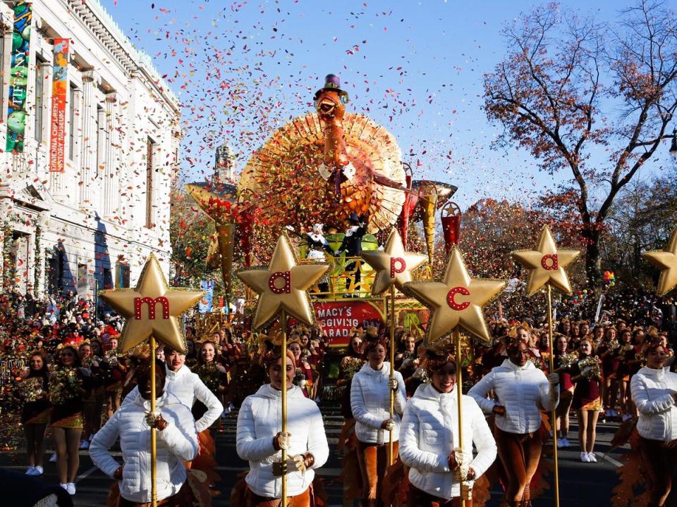 Performers walk in front of Macy's Tom Turkey float in the Thanksgiving Day Parade in New York (AP)