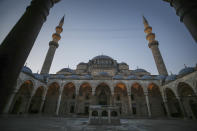 A deserted courtyard of the mosque is seen as few face masked people allowed to offer the Eid al-Fitr prayer amid concerns of the coronavirus outbreak at historical Suleymaniye Mosque, in Istanbul, early Sunday, May 24, 2020. Muslims in the world are marking a muted and gloomy religious festival of Eid al-Fitr, the end of the fasting month of Ramadan - a usually joyous three-day celebration that has been significantly toned down due to the new coronavirus outbreak. (AP Photo/Emrah Gurel)