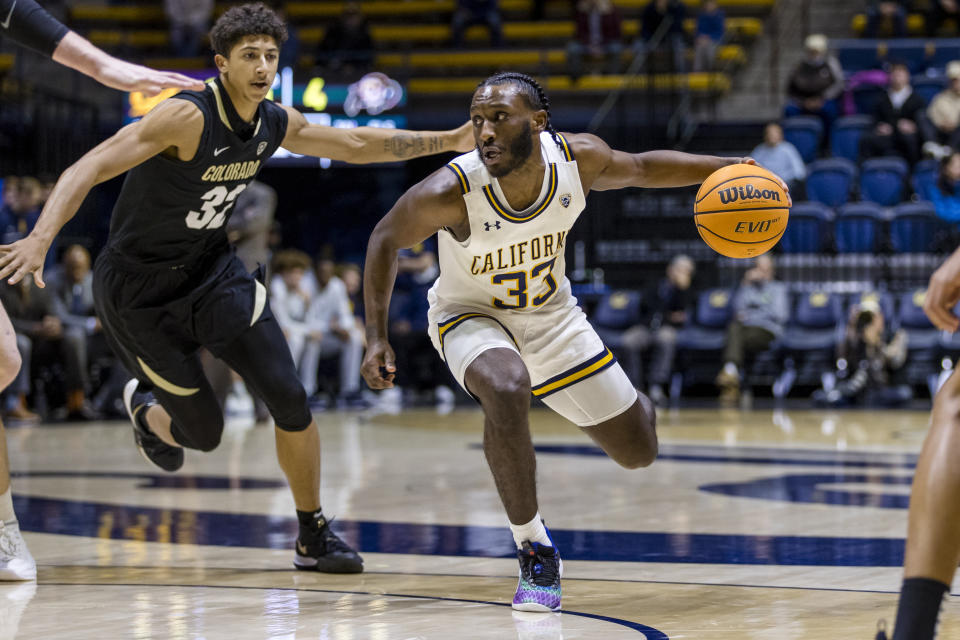 California guard DeJuan Clayton (33) drives past Colorado guard Nique Clifford (32) during the first half of an NCAA college basketball game in Berkeley, Calif., Saturday, Dec. 31, 2022. (AP Photo/John Hefti)