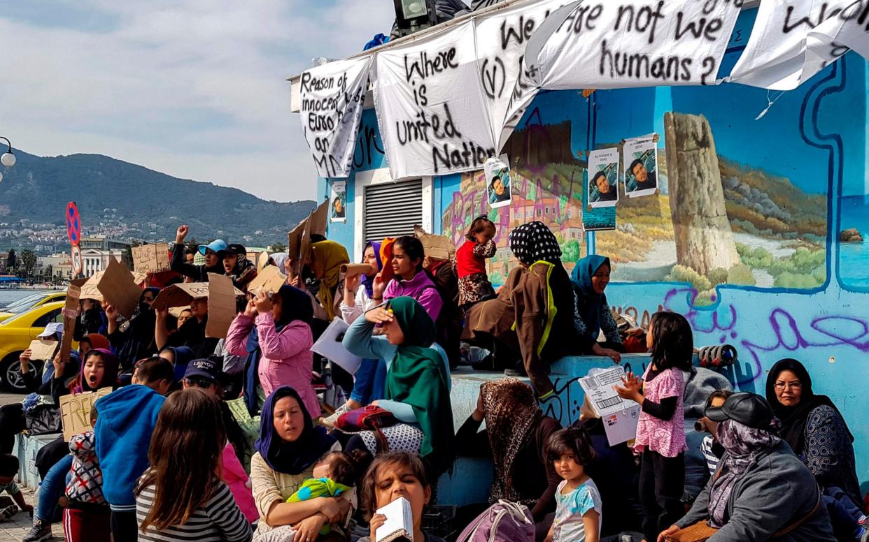 Refugees and migrants protest on Lesbos, demanding to be allowed to leave the island - AFP