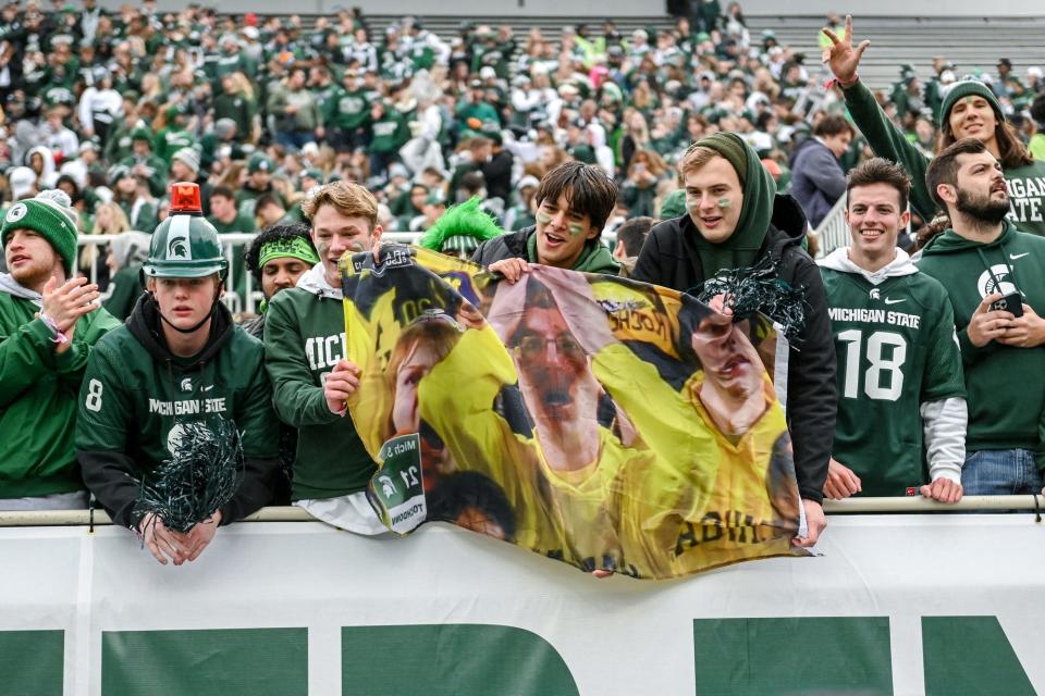 Michigan State fans cheer before a game against Michigan on Saturday, Oct. 30, 2021, at Spartan Stadium in East Lansing, Mich. Lawmakers recently reintroduced legislation that would allow colleges to sell alcohol at venues during certain sporting events.