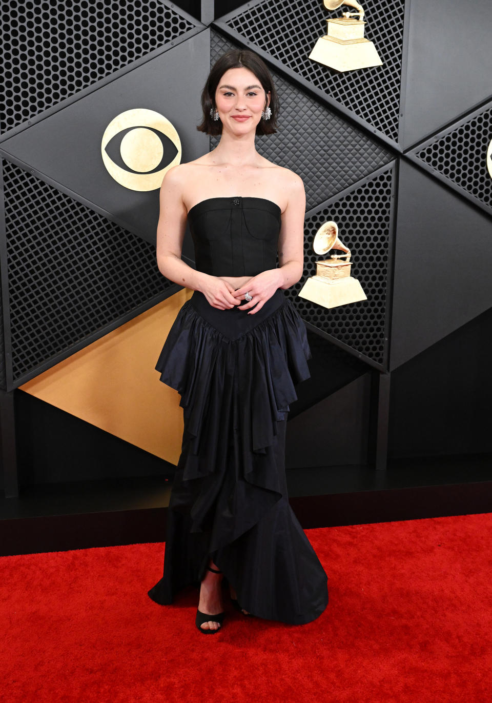 Gracie Abrams wears chanel couture dress, high-low, ruffles, at the 66th Annual GRAMMY Awards held at Crypto.com Arena on February 4, 2024 in Los Angeles, California.