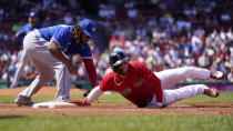 Boston Red Sox's Alex Verdugo, right, dives back safely, beating the tag by Toronto Blue Jays first baseman Vladimir Guerrero Jr., on a pick-off attempt in the second inning of a baseball game at Fenway Park, Wednesday, July 28, 2021, in Boston. (AP Photo/Charles Krupa)