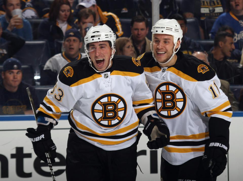 BUFFALO, NY - NOVEMBER 03: Brad Marchand #63 (L) of the Boston Bruins scores his first NHL goal in the first period against the Buffalo Sabres and is joined by Gregory Campbell #11 (R) at the HSBC Arena on November 3, 2010 in Buffalo, New York. The Bruins defeated the Sabres 5-2.(Photo by Bruce Bennett/Getty Images)