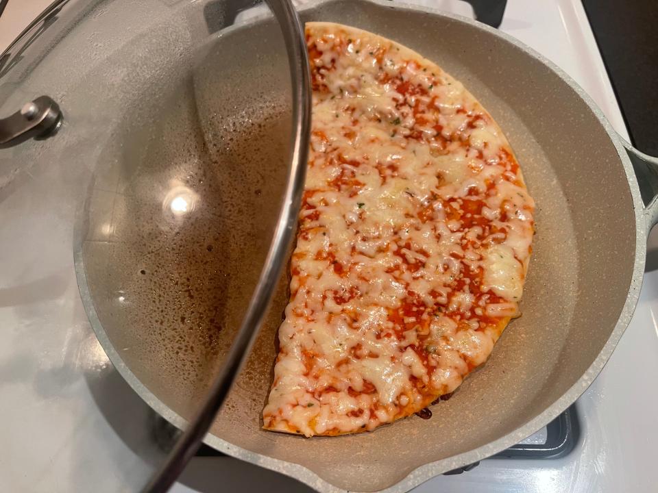 Pizza with melted cheese in a pan
