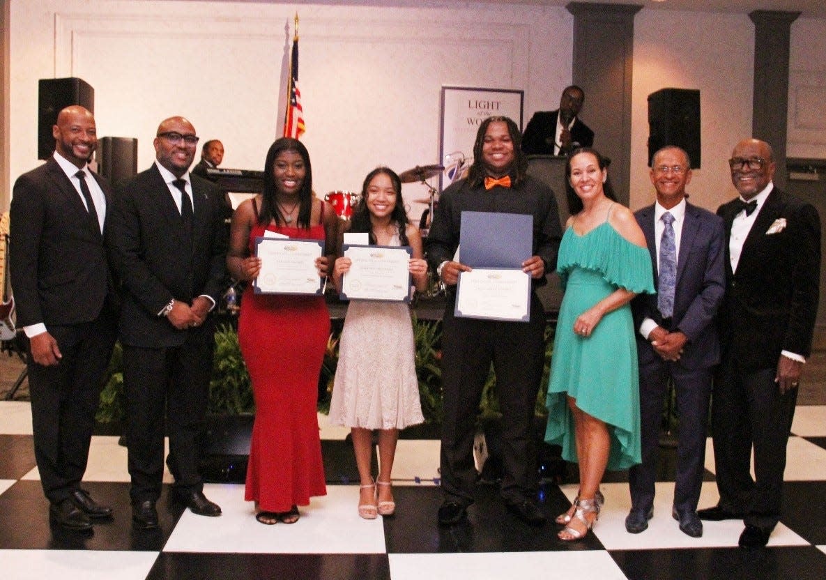 BATTIE AWARDS: Three aspiring high school students were awarded scholarships during the 10th annual A. Jean Battie Scholarship Fund Banquet presented recently by the Community Foundation of Sarasota County and Light of the World International Church. Nora Ngo Mitchell earned a $3,500 scholarship for winning the Black history essay contest. Craivontae Koonce ($2,500) and Yaradji Nazarie ($1,500) were runners-up. This year’s prizes awards were boosted by $2,000 thanks to Lynn and Sheryl Williams of the Oyamacor corporation. From left, Sarasota Mayor Kyle Scott Battie, Pastor Kelvin L. Lumpkin, Nazarie, Mitchell, Koonce, Dalila Lumpkin, Executive Pastor Peter Greenidge, and scholarship chair Henry “Hank” Battie. Visit ajeanbattiescholarship.org.