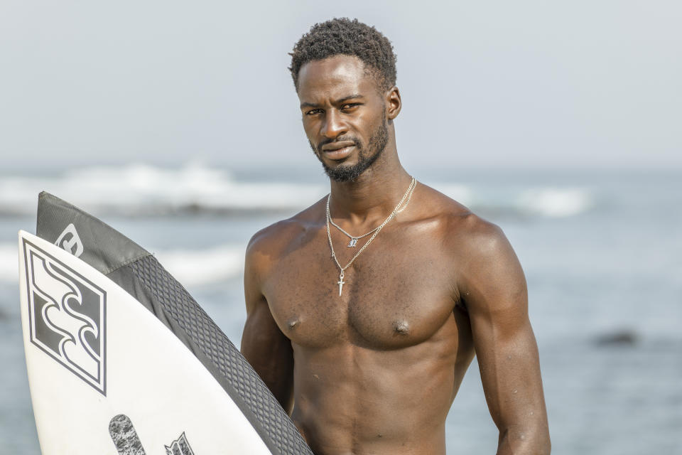 Cherif Fall, Senegal's number one surfer paddles to the wave in the Atlantic Ocean in Dakar, Senegal, Wednesday, Feb. 28, 2024. Instead of training in the waves off his Senegal homeland, Fall was wistfully preferring to be in Puerto Rico, where the last surfing qualifying competition for the Paris Olympics ends on Saturday. Senegal had nobody there to try and claim the last 14 spots for men and women because there was no money to send them, Fall says. (AP Photo/Sylvain Cherkaoui)