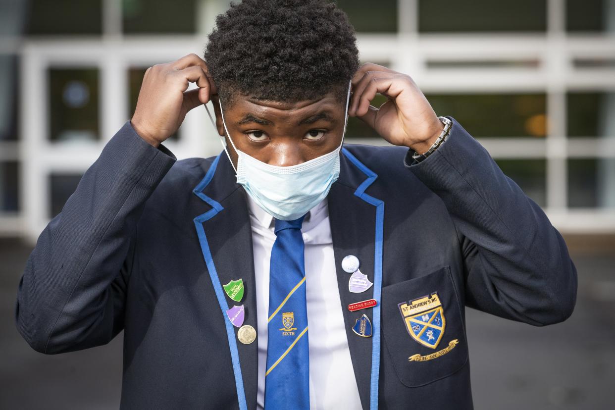 Jordy Yahve puts on his face mask before heading inside for lessons at St Andrew’s RC Secondary School in Glasgow (Jane Barlow/PA) (PA Wire)