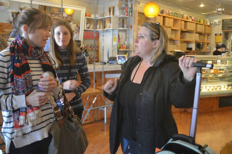 Lori Pickhardt (right) is showing two tourists directions at the end of the food tour.